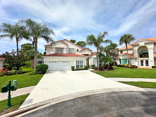 mediterranean / spanish home with a garage and a front lawn