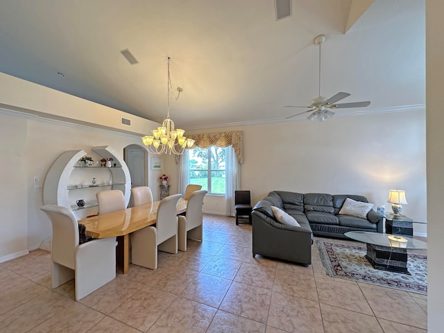 tiled dining room with ornamental molding, ceiling fan with notable chandelier, and vaulted ceiling