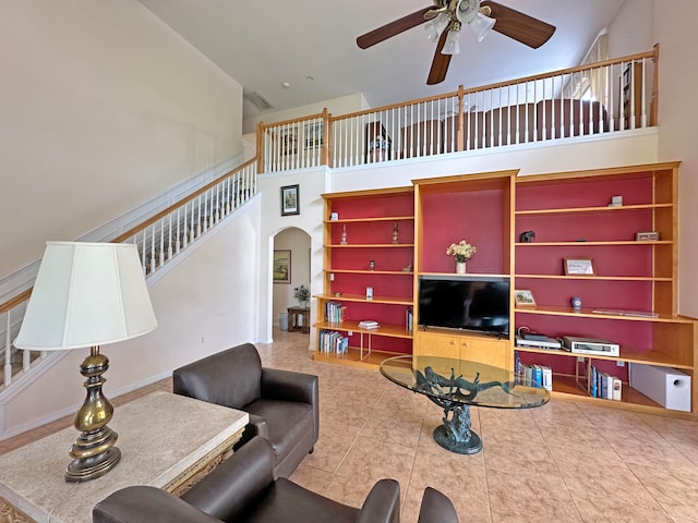 living room featuring ceiling fan, high vaulted ceiling, and tile patterned floors