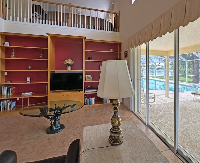 living room featuring light tile patterned floors and a high ceiling