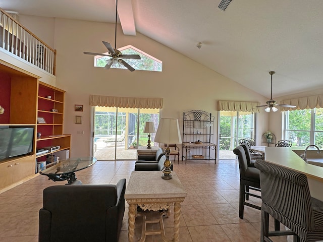 living room with light tile patterned floors, ceiling fan, and plenty of natural light