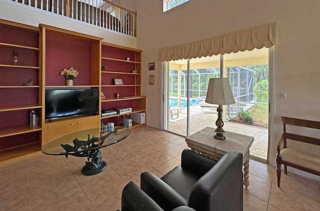 tiled living room featuring a wealth of natural light and a high ceiling