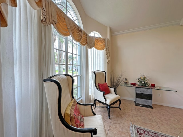 sitting room featuring crown molding, vaulted ceiling, and light tile patterned floors