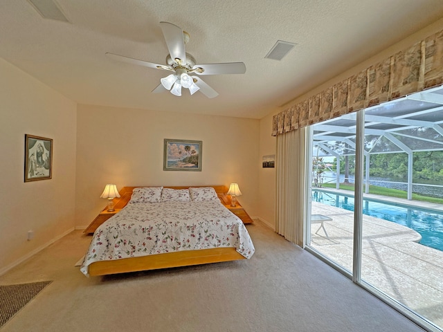 bedroom with a textured ceiling, access to outside, carpet, and ceiling fan