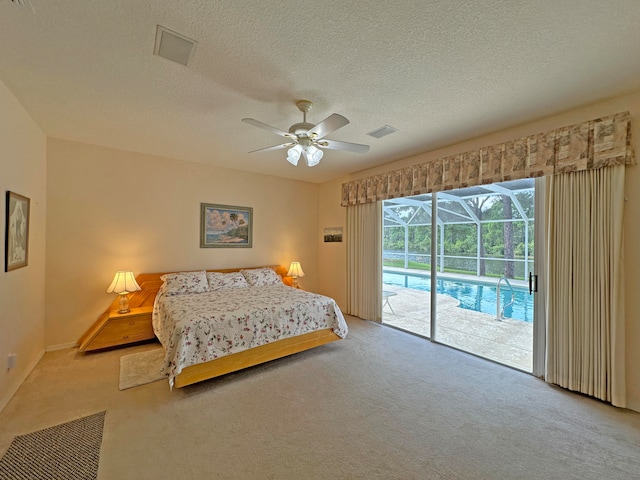 carpeted bedroom with ceiling fan, a textured ceiling, and access to exterior