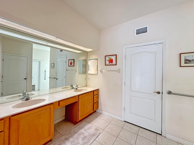 bathroom featuring tile patterned flooring and vanity