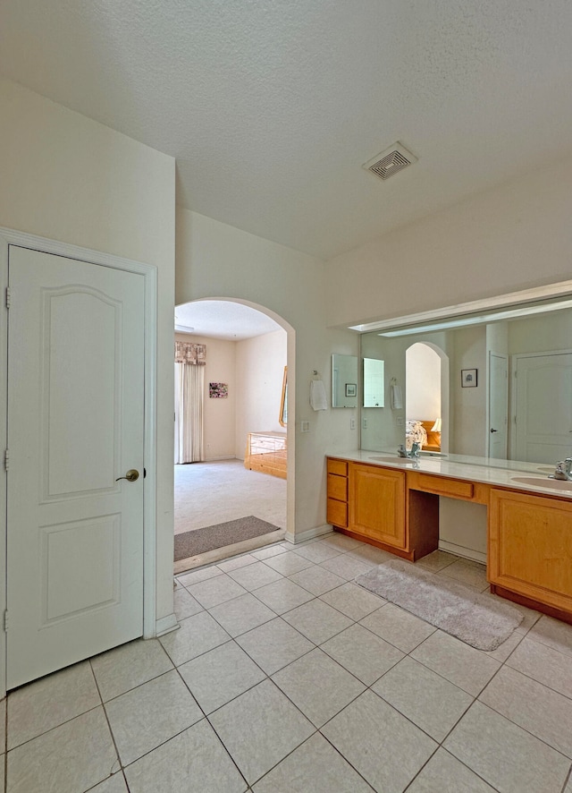 bathroom featuring vanity, a textured ceiling, and tile patterned floors