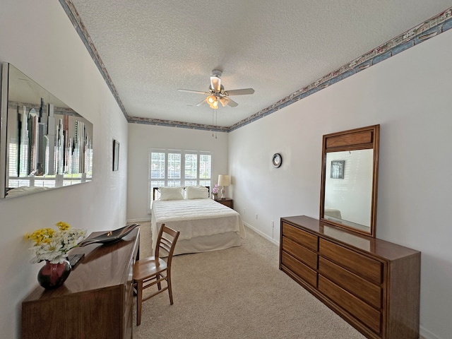 carpeted bedroom featuring multiple windows, a textured ceiling, and ceiling fan