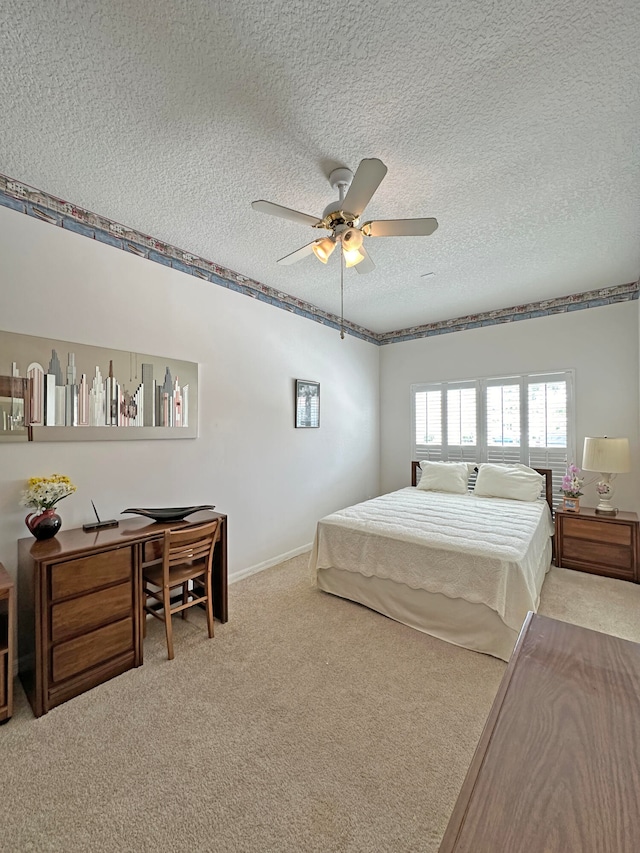 bedroom with light carpet, ceiling fan, and a textured ceiling