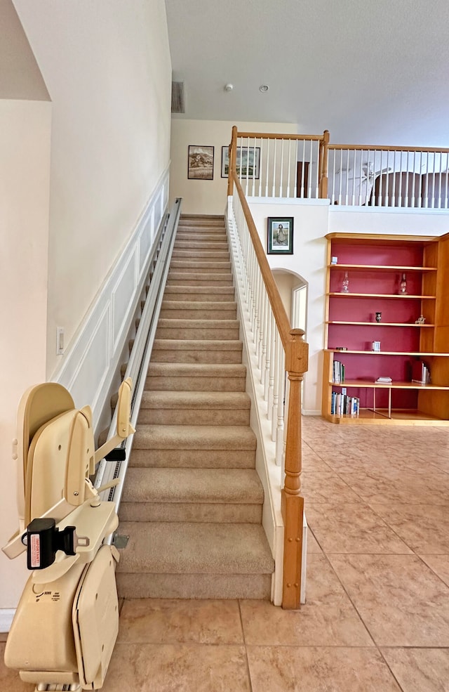 stairway with tile patterned floors