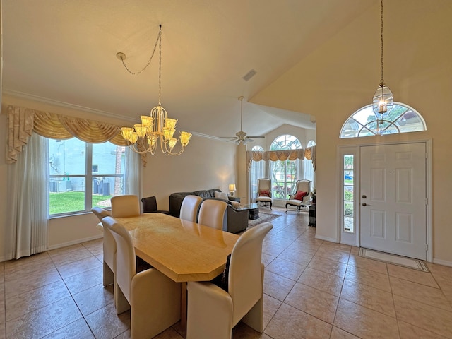 dining space featuring high vaulted ceiling and a chandelier