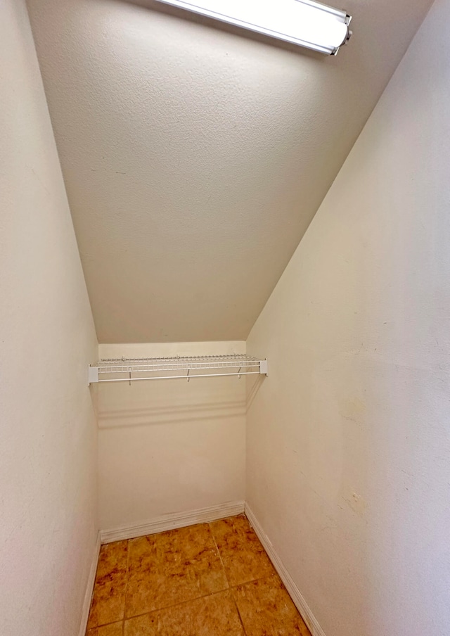 spacious closet featuring light tile patterned flooring