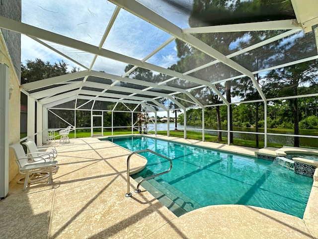 view of pool featuring an in ground hot tub, a lanai, and a patio area