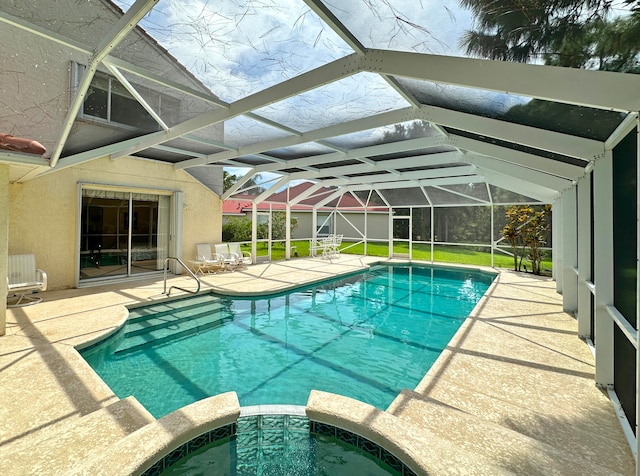 view of pool featuring glass enclosure and a patio area