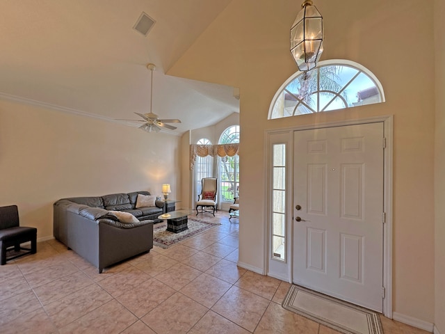 entrance foyer featuring light tile patterned flooring, ceiling fan, and high vaulted ceiling