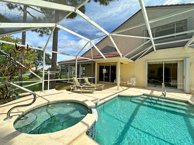 view of pool with glass enclosure, an in ground hot tub, and a patio