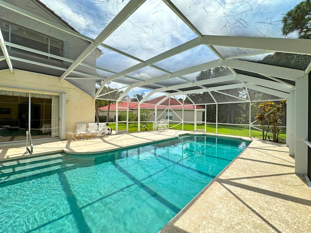 view of pool with a lanai and a patio