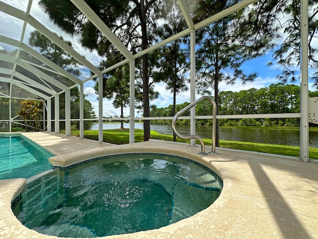 view of swimming pool with a water view, a patio, and a lanai