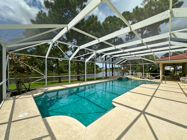 view of pool featuring glass enclosure and a patio area