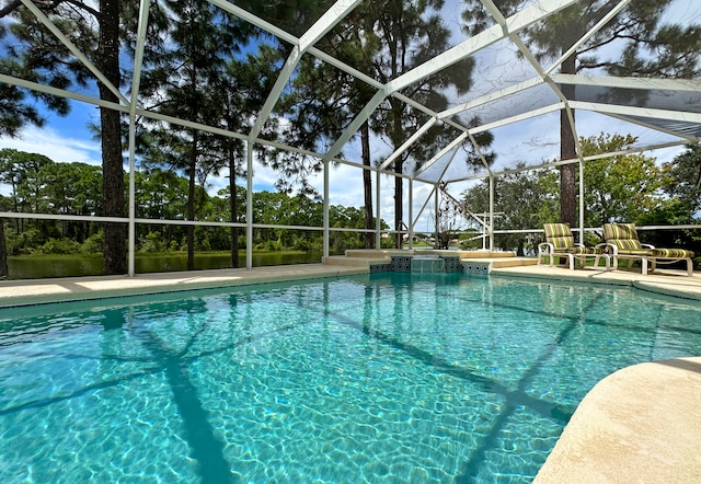 view of swimming pool featuring a lanai and a patio area