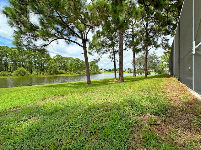 view of yard featuring a water view and a lanai