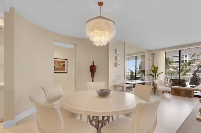 dining room featuring light tile patterned flooring and a chandelier