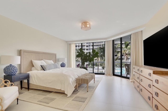 bedroom featuring access to outside, expansive windows, and multiple windows