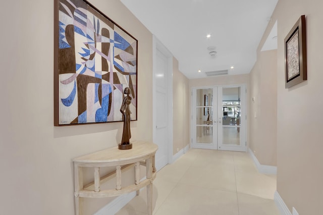 corridor with french doors and light tile patterned floors