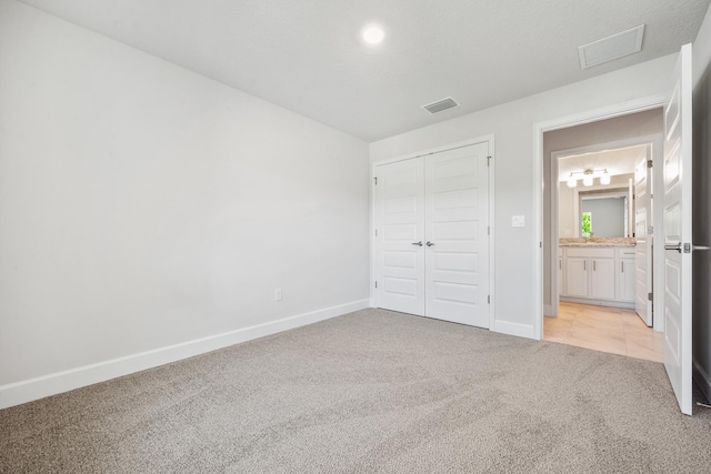 carpeted empty room with ceiling fan and sink