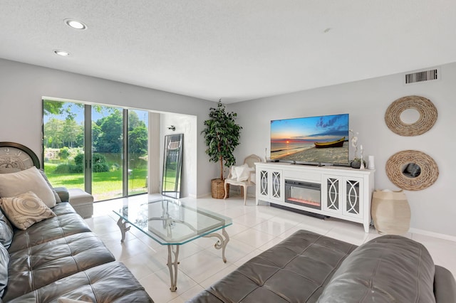 living room with a textured ceiling and tile patterned floors