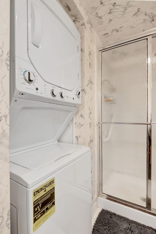 laundry area featuring stacked washer / drying machine