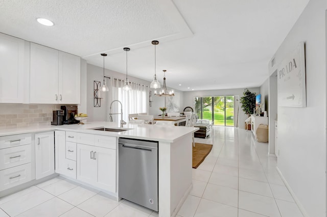 kitchen featuring dishwasher, sink, white cabinetry, kitchen peninsula, and light tile patterned floors