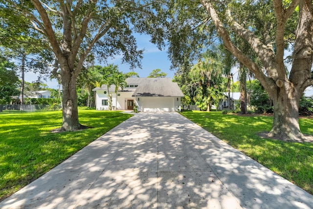 view of front of house with a garage and a front lawn