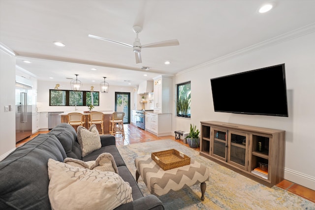 living room featuring ceiling fan, crown molding, and light tile patterned floors