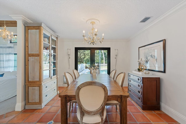 dining area with an inviting chandelier, a textured ceiling, visible vents, and baseboards