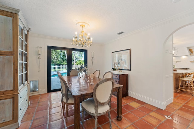 dining room with a textured ceiling, visible vents, a chandelier, crown molding, and arched walkways