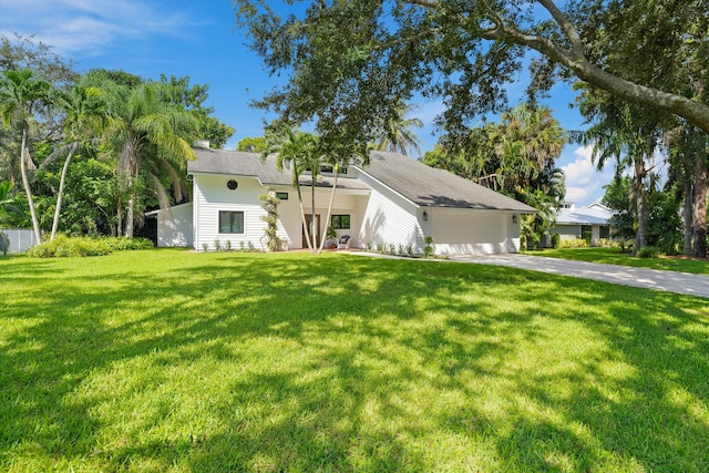 view of front of house with a garage and a front lawn