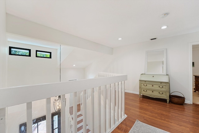 hallway with recessed lighting, baseboards, an upstairs landing, and wood finished floors