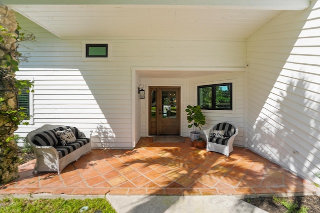 view of exterior entry featuring a patio