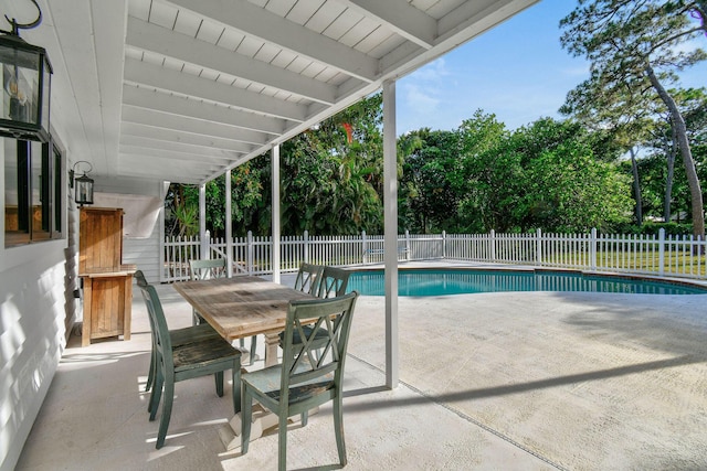 view of swimming pool with a patio area, outdoor dining area, a fenced in pool, and a fenced backyard