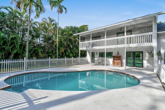 view of pool featuring fence, a patio, a fenced in pool, and a ceiling fan