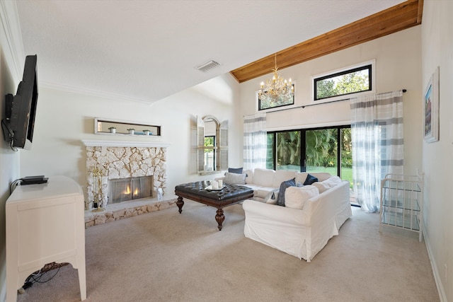 living room with a high ceiling, a fireplace, an inviting chandelier, and light carpet