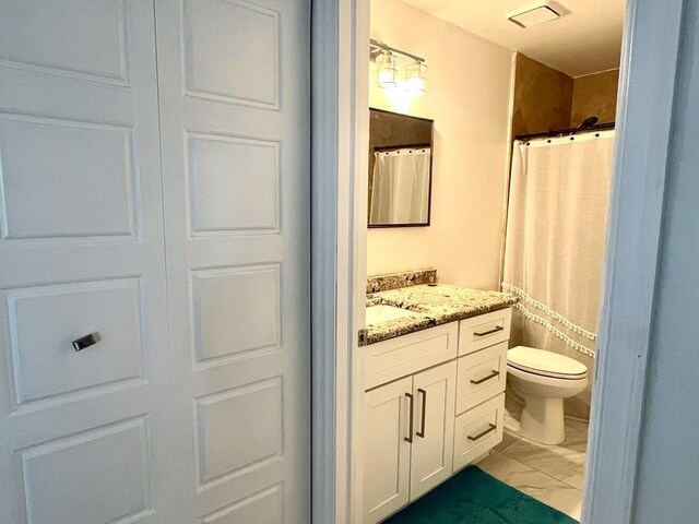 bathroom featuring toilet and vanity