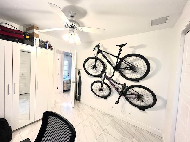 interior space with ceiling fan