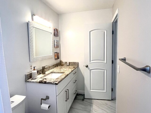 bathroom featuring toilet and vanity