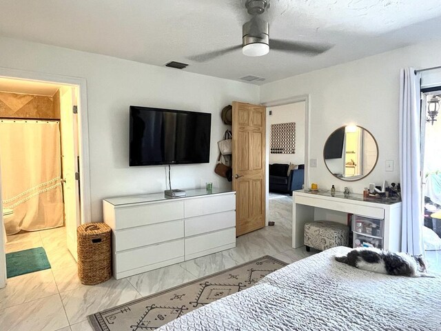 bedroom featuring ceiling fan and ensuite bath