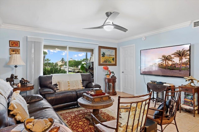 tiled living room with ceiling fan and crown molding