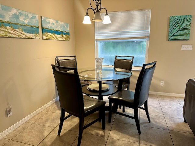 tiled dining area featuring baseboards