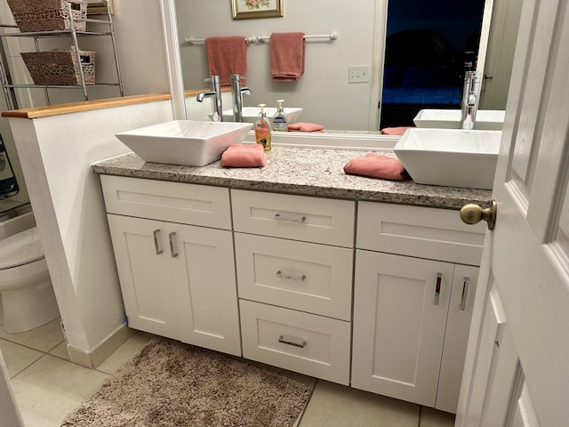 full bathroom featuring tile patterned floors, toilet, and vanity