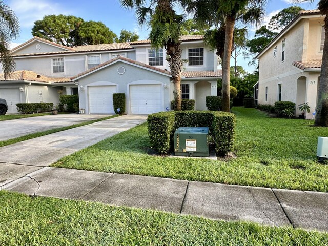 view of front of property with a garage and a front yard